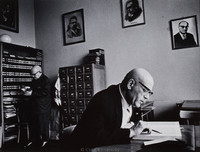 Researchers at the Jewish Historical Institute in Warsaw.  Scholarly works regarding Jewish culture, history, etc. are still being written here.  Pictures on the wall are (left - right) Shalom Aleichem (writer), Isaac Peretz (writer), Dr. Meir Balaban (historian of Polish Jewry, died in the Warsaw ghetto, 1942), and Professor Ber Mark (historian and director of the institute until his death in 1966).  The building contains rare books, paintings, photographs and various paraphernalia retained from the Holocaust.